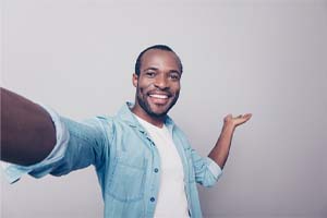 man taking a selfie after cosmetic dentistry in Fort Worth