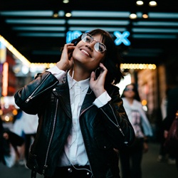 person walking down a city street listening to music