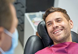 Dentist explaining cost of emergency dentistry in Fort Worth to patient