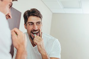 Man brushing teeth to prevent dental emergencies in Fort Worth