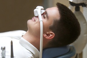 young man lying down with nitrous oxide mask over his nose