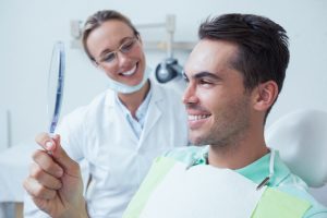 dental professional next to patient