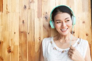 person smiling with headphones on