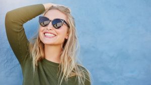 woman smiling and wearing sunglasses