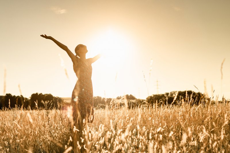 Woman celebrates in the sun.