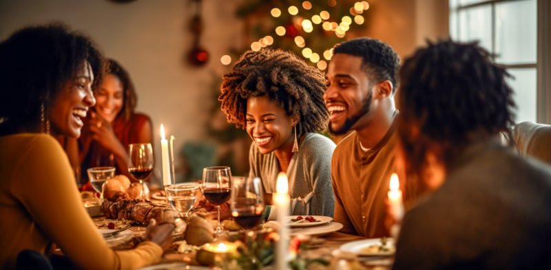 A family enjoying Thanksgiving dinner with good oral health