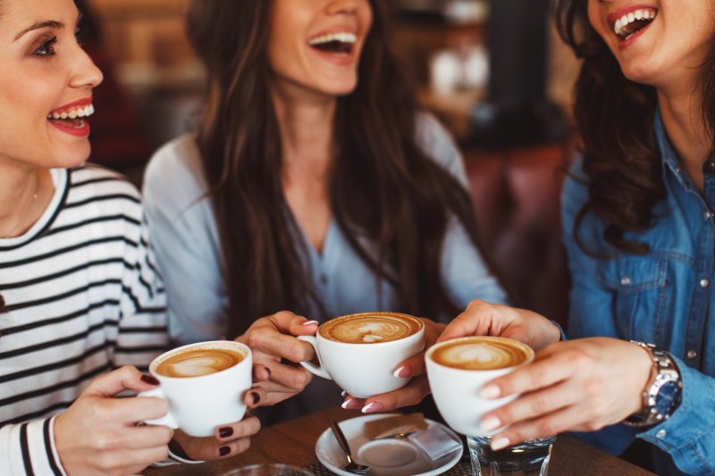 Friends out enjoying coffee after getting their porcelain veneers