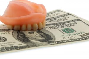 Dentures on a stack of cash