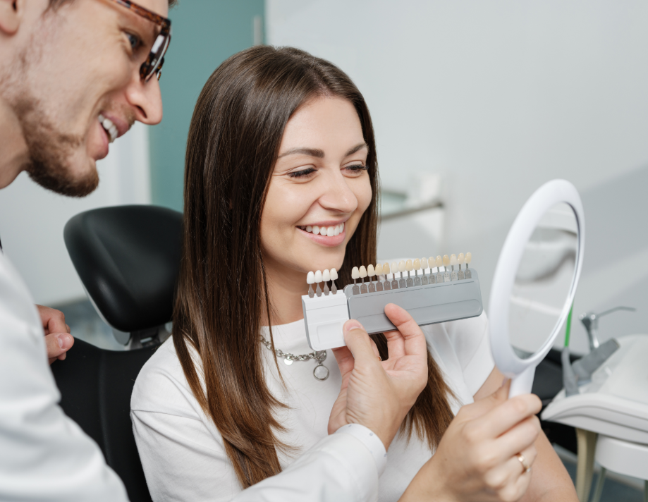 Dentist showing patient veneer options